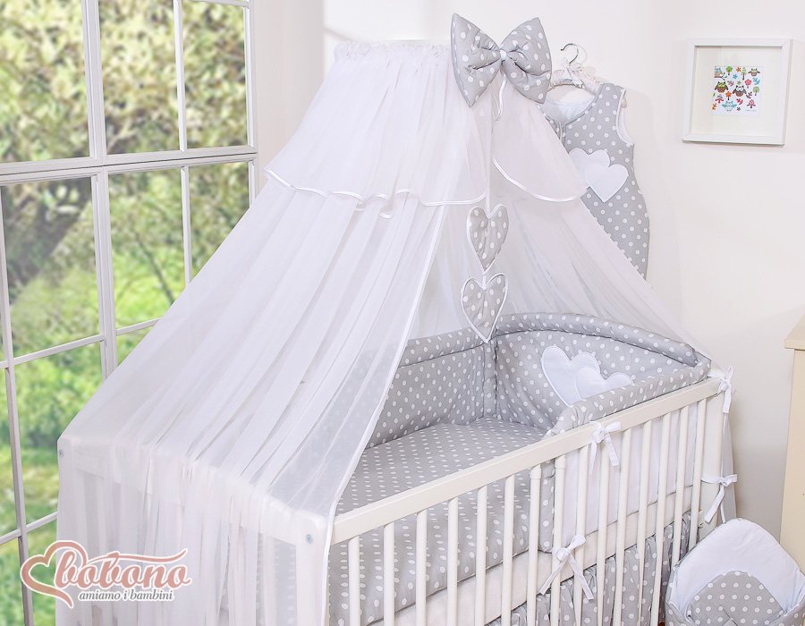 Large mosquito net for baby's bed made of white chiffon with hanging hearts and a bow - dots on gray