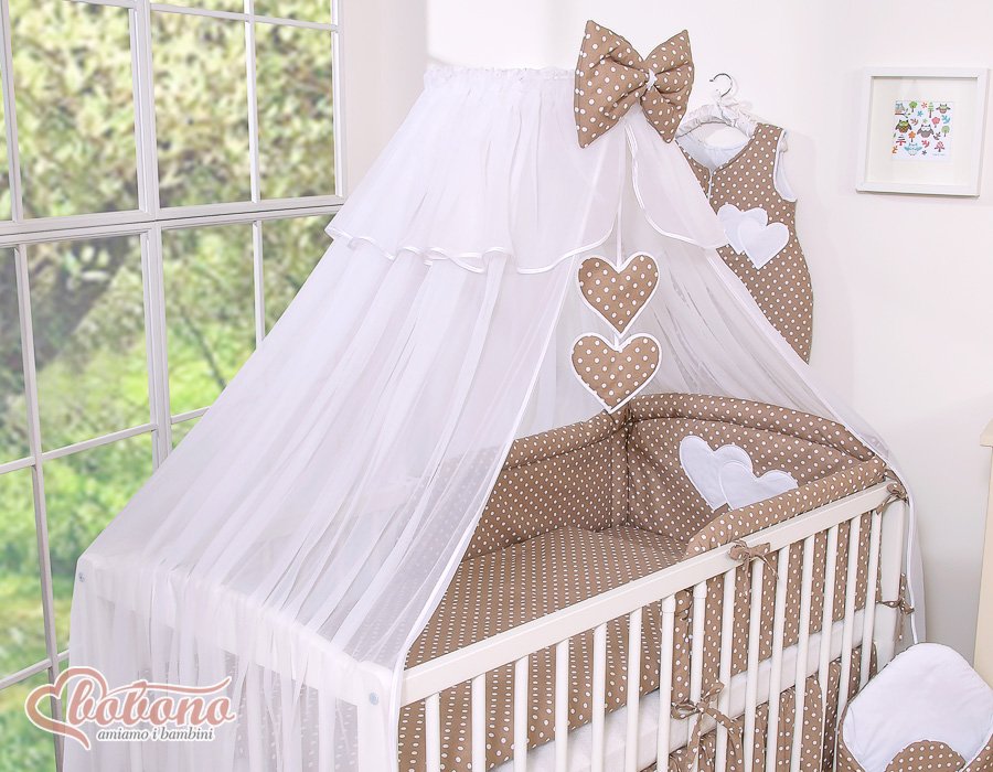 Large mosquito net for baby's bed made of white chiffon with hanging hearts and a bow -dots on brown